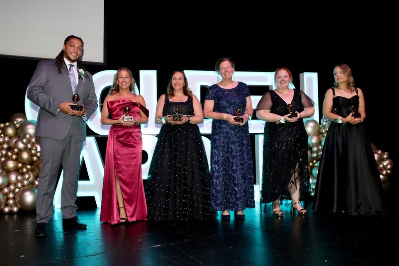 Golden Apple Teacher Award recipients Bryce Thomas, from left, Shawna Sterling, Chelsea Spinello-Johnson, Katie Volk, Hayley Gotzsche, and Kelsey Zammuto, are pictured April 24, 2026, during the Golden Apple Foundation’s Excellence in Education Banquet at Rockford's Tebala Event Center.