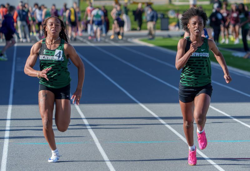 Richwoods’ Brianna Johnson, right, outsprints teammate Jaydah Green for a victory in the 100-meter dash during the Peoria All-City Track and Field Meet on Wednesday, April 29, 2026 at Peoria Stadium. Johnson won with a time of 12.49 while Green finished at 12.70.