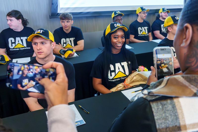 Manual senior Jalliyah Pearson poses for photos after signing on with Caterpillar Inc. during a ceremony Friday, May 1, 2026 at the Caterpillar Visitors Center in Downtown Peoria. Pearson and 15 other high schoolers recently completed Caterpillar’s Essentials for Life (E4L) Student Trainee Program which provides interested students with hands-on training and mentorship towards a career in modern manufacturing at the Fortune 500 company.