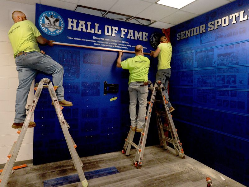 Ace Signs installers work on the Hall of Fame wall at Riverton High School Friday, May 1, 2026.