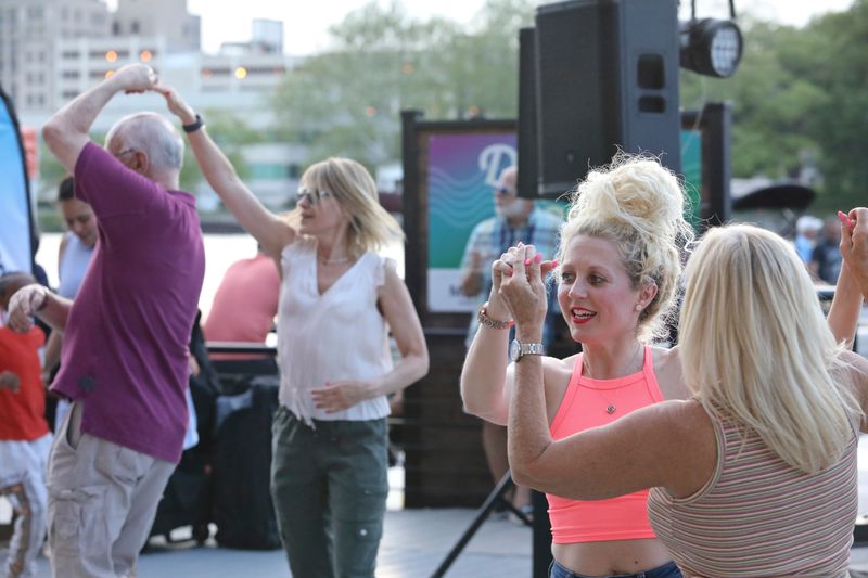 People dance to live music at Dinner on the Dock May 19, 2022, at the Prairie Street Brewing Co.
