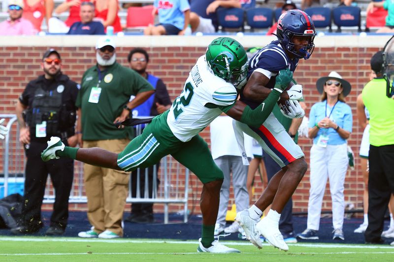 Sep 20, 2025; Oxford, Mississippi, USA; Mississippi Rebels wide receiver Deuce Alexander (11) runs after a catch as Tulane Green Wave defensive back KC Eziomume (12) attempts to make the tackle during the fourth quarter at Vaught-Hemingway Stadium. Mandatory Credit: Petre Thomas-Imagn Images