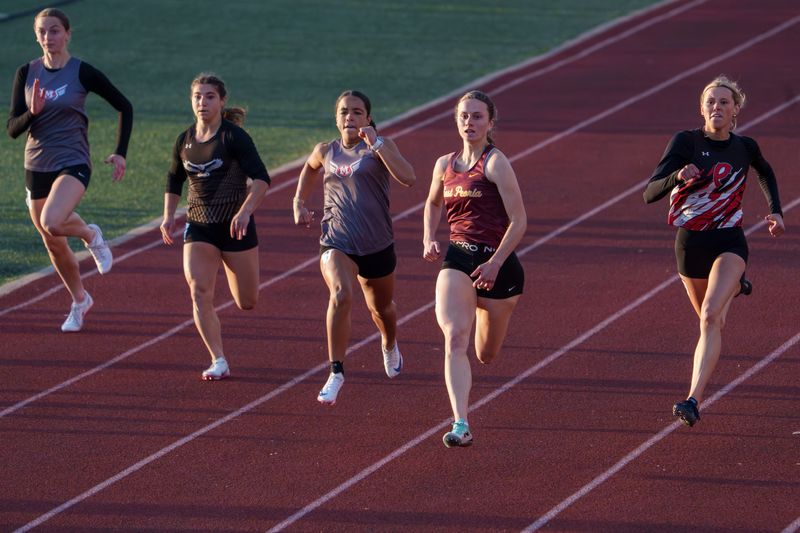 East Peoria’s Ava Alt, second from right, sprints to victory in the 100-meter dash Wednesday, May 6, 2026 at the Mid-Illini Girls Track and Field Championships at EastSide Centre in East Peoria.
