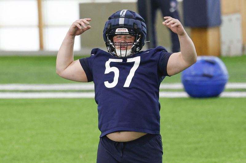 May 8, 2026; Lake Forest, IL, USA; Chicago Bears offensive lineman Joshua Kreutz (57) stretches during Rookie Minicamp at Halas Hall. Mandatory Credit: Kamil Krzaczynski-Imagn Images