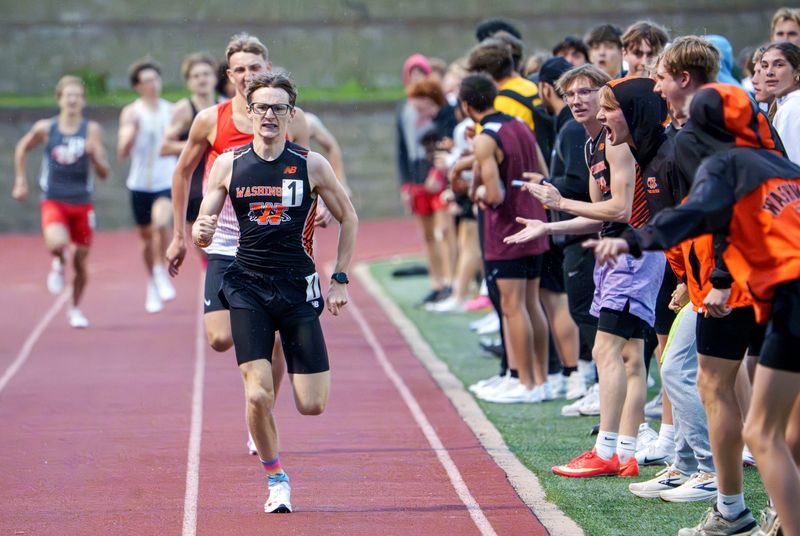 Washington’s Ben Gorsage gets a little encouragement from the crowd as he pulls ahead of Metamora’s Zach Born to win the 800-meter run during the Mid-Illini Track and Field Championships on Tuesday, May 12, 2026 at EastSide Centre in East Peoria. Gorsage recorded a time of 1:53.08 for the title.