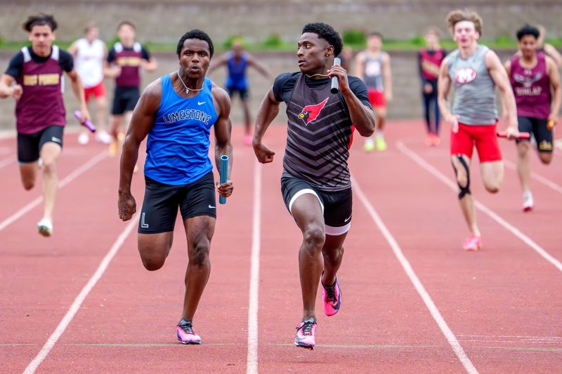 Metamora's Jaiduan Cranford, right, takes a peek back at his opponent, Limestone's DJ Brooks, in the anchor leg of the 4X100-meter relay during the Mid-Illini Track and Field Championships on Tuesday, May 12, 2026 at EastSide Centre in East Peoria. Metamora took the conference title with a time of 41.96, with Limestone on their heels at 42.14.