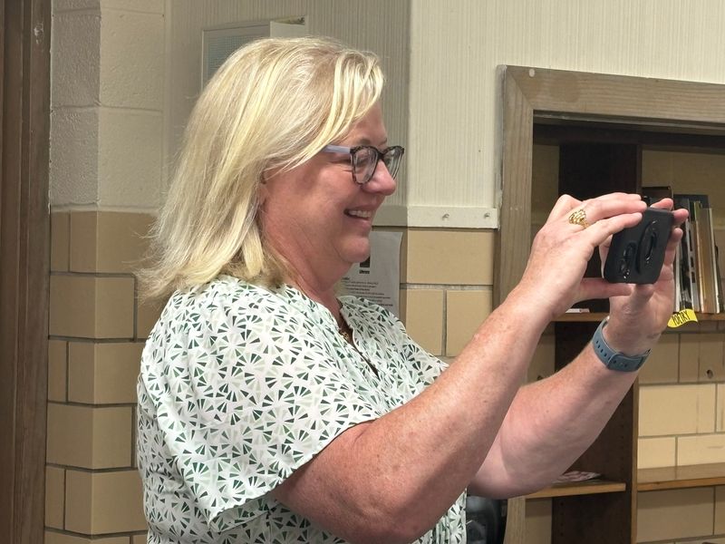 St. Patrick Catholic School Principal Bridget Timoney takes a photo of several visitors at the school's open house May 16, 2026. Timoney, a longtime educator in St. Louis, had worked for St. Patrick School for several years before becoming its principal in September. The school holds its last day of classes May 21, 2026.