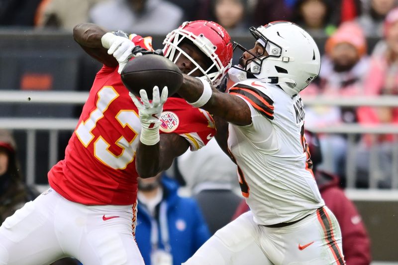 Dec 15, 2024; Cleveland, Ohio, USA; Kansas City Chiefs safety Nazeeh Johnson (13) and Cleveland Browns wide receiver Elijah Moore (8) go for a pass during the first half at Huntington Bank Field. Mandatory Credit: Ken Blaze-Imagn Images