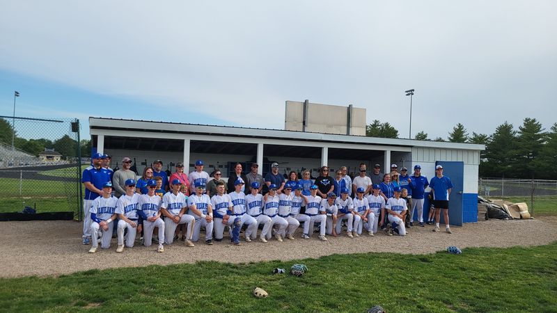 The Petersburg PORTA baseball team and players' families take photos after winning a program-record 28th game on Thursday, May 21, 2026.