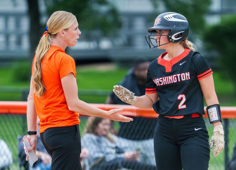 Washington head coach Stephanie Lawson chats with Maddy Meischner at third base as the Panthers battle Normal Wes in the Class 3A girls softball regional title game Friday, May 22, 2026 in Washington. The Panthers defeated the Wildcats 3-1 to advance to the Lincoln Sectional.