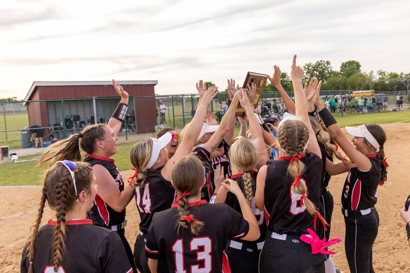 The Stillman Valley Cardinals softball team celebrate with the plaque in their 11-5 victory over North Boone in the Class 2A sectional final on May 29, 2026 at Marengo High School.