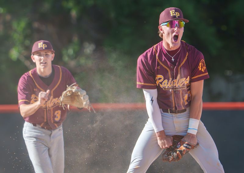 East Peoria's Jackson Ahrens, right, celebrates after turning a double play in the seventh inning to end the game and give the Raiders a 1-0 win over Metamora in their Class 3A baseball sectional semifinal Wednesday, June 3, 2026 at Washington Community High School. At left is East Peoria's Ayden Knight.