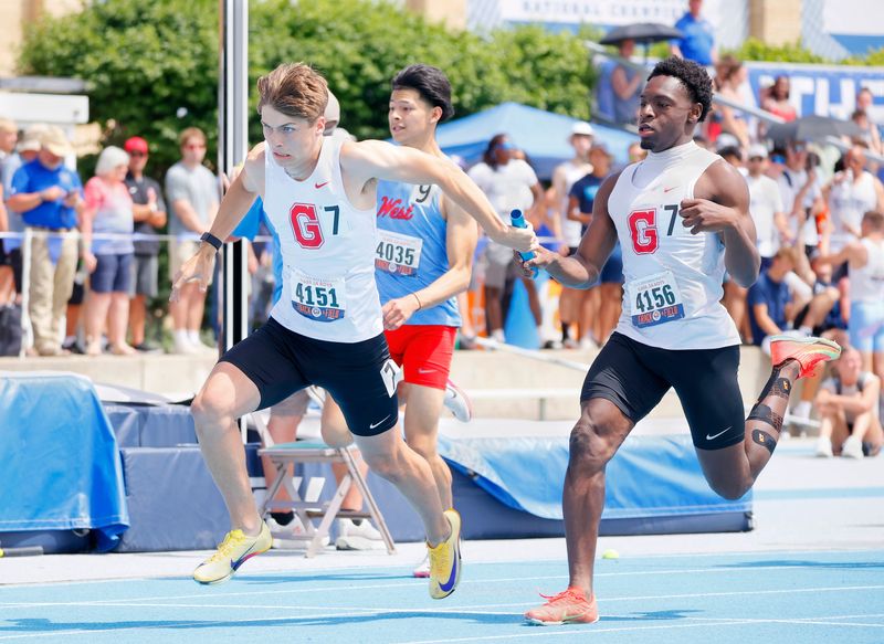 Chatham Glenwood's Larry Wills (right) and Colton Ladage exchange the baton for the final leg of the 4x200-meter relay of the Class 3A Boys Track and Field State Finals at O'Brien Field in Charleston on Saturday, May 30, 2026.