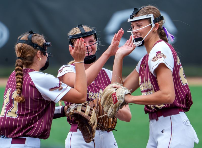 Dunlap pitcher Sutton Centoni, right, gets some love from teammates Hallie Reed, left, and Rachel Mies after striking out an Antioch batter in the second inning of the Class 3A softball state semifinals Friday, June 5, 2026 at the Louisville Slugger Sports Complex in Peoria. The Eagles fell to the Sequoits 6-1.