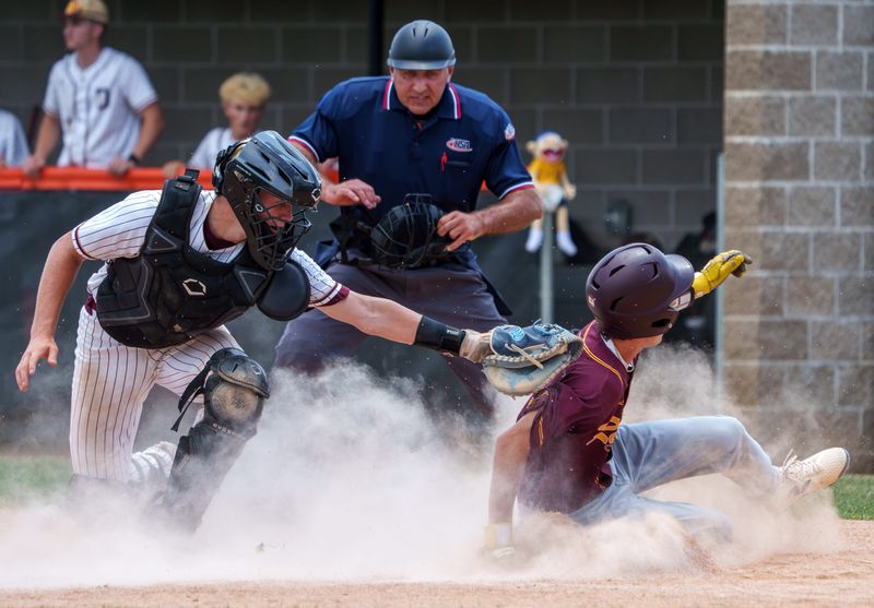 East Peoria’s Breckin Parker, right, slides safely into home plate to score against Dunlap in the sixth inning of their Class 3A baseball sectional title game Saturday, June 6, 2026 at Washington Community High School. The Raiders defeated the Eagles 5-3.