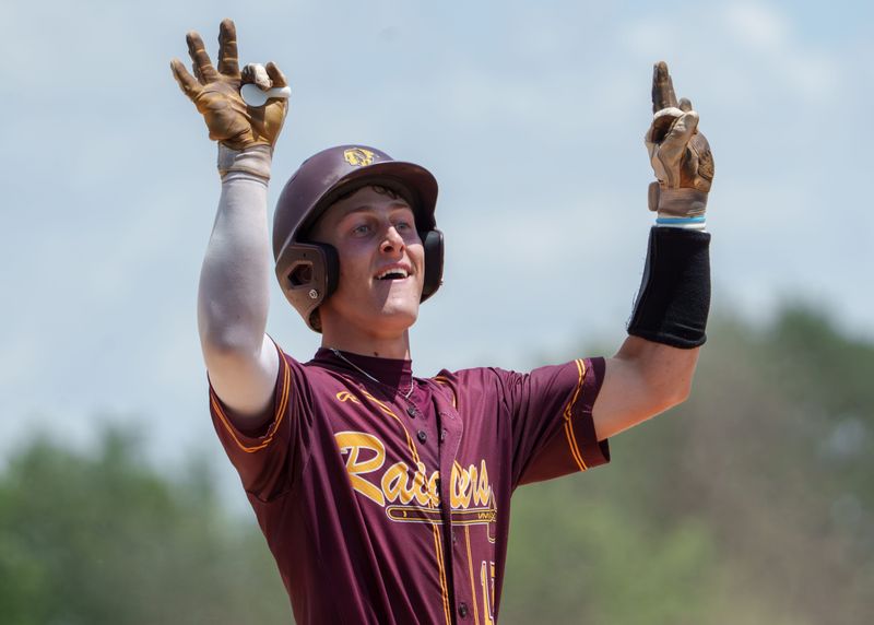 East Peoria’s Jackson Ahrens celebrates after his RBI triple against Dunlap in the sixth inning of their Class 3A baseball sectional title game Saturday, June 6, 2026 at Washington Community High School. The Raiders defeated the Eagles 5-3.