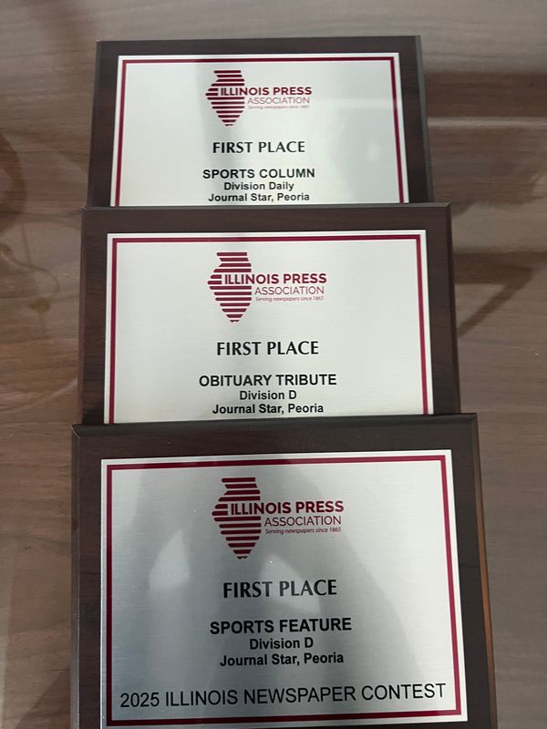 Three first-place plaques awarded to Journal Star sportswriter Dave Eminian by the Illinois Press Association.