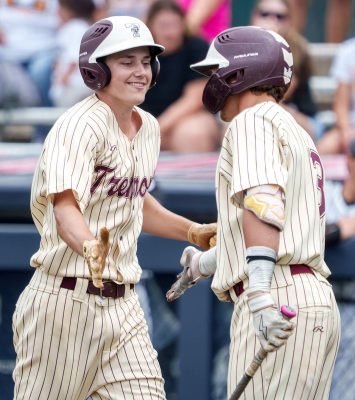 Tremont's Andrew Dawson, right, congratulates teammate Justin Muselman after scoring against Putnam County in the third inning of their Class 1A baseball state title game Saturday, June 13, 2026 at Illinois Field in Champaign.