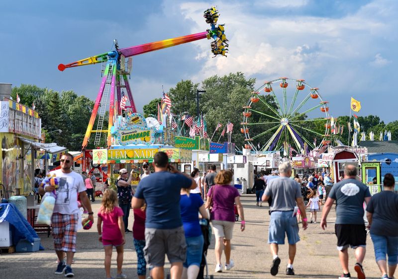 People walk the midway Wednesday, Aug. 1, 2018, at the 164th Ingham County Fair in Mason. The term "midway" originated from the Chicago World Fair in Chicago, Illinois, in 1893. The Ingham County fair runs through Aug. 4.

636687930365004617-MD7-4718.jpg