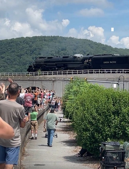 Train watchers wave to Big Boy No. 4014 as it crosses the Stone Bridge in Johnstown, PA on July 11, 2026, during its coast-to-coast tour of America.