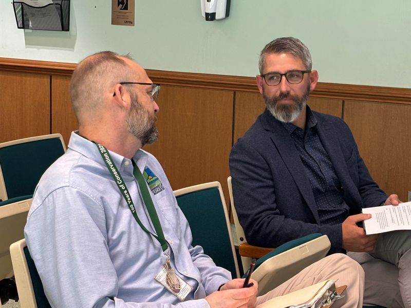 Erick Huck, senior landscape architect for the Illinois Department of Natural Resources, left, converses with Russell Orrill, deputy director for IDNR, prior to the Springfield Committee of the Whole July 14, 2026. Orrill presented on plans for the new Y Block design, which will include a natural amphitheater and permanent stage.