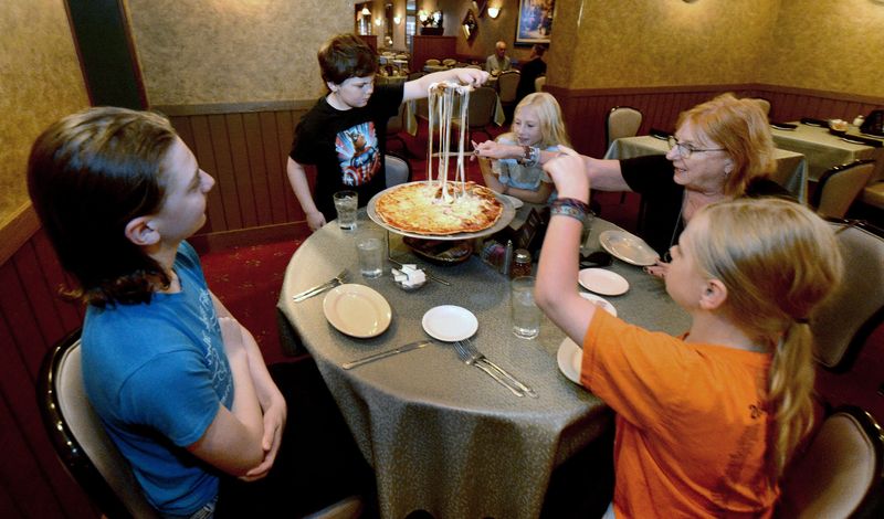 Customers dig into a pizza at Saputo's Italian restaurant on Wednesday, July 15, 2026, in Springfield. The restaurant was voted as the best Italian restaurant in Springfield in the 2025 Community Choice Awards.