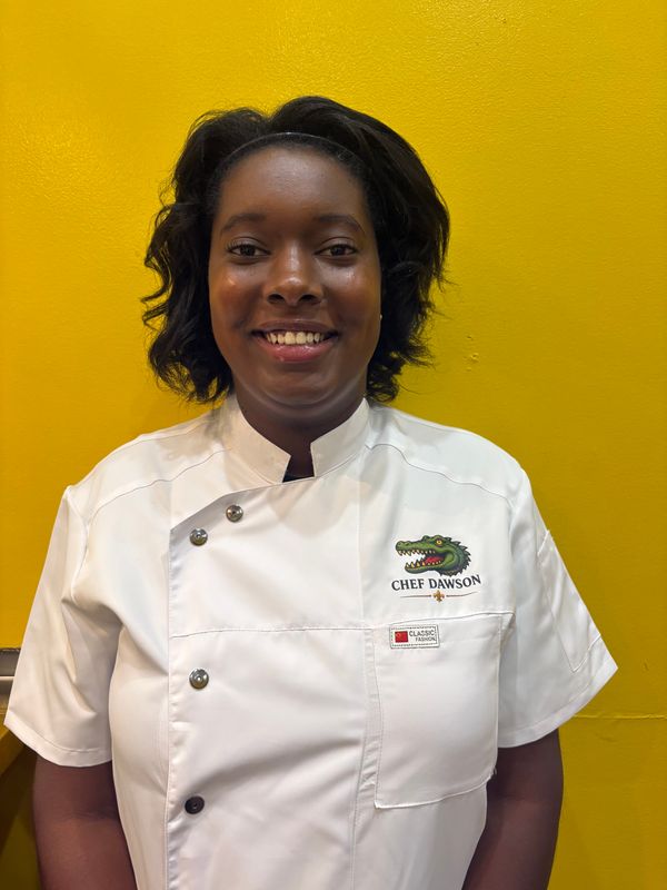 Chef Journe Dawson poses for a picture wearing her chef's jacket for her family business, Creole Smoke.