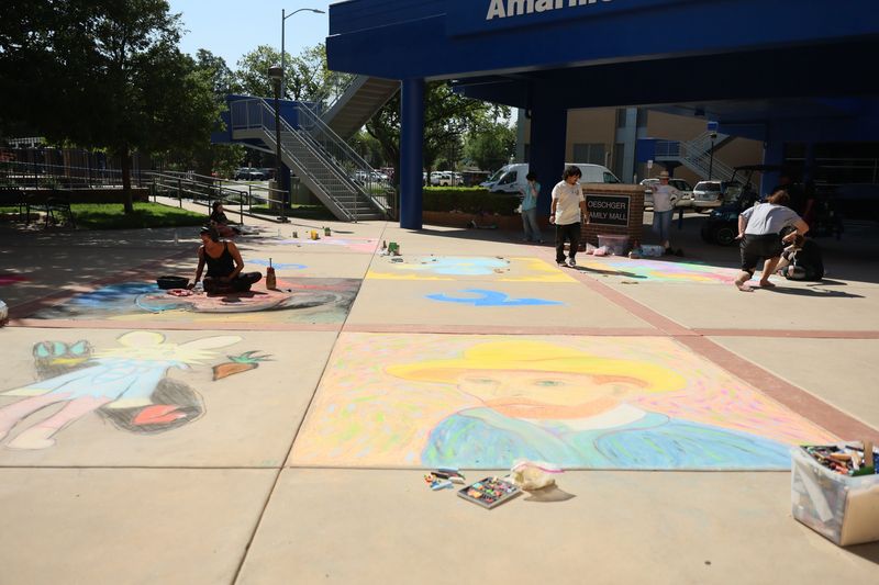 The 8th annual Chalk It Up sidewalk art competition was held Saturday, July 25 at Amarillo College's Washington Street Campus. The free community event transformed the Oeschger Family Mall into a colorful outdoor gallery. Mallory Prucha, left, won third place for her entry, on growth and expansion.