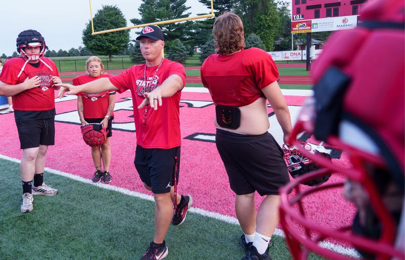 Dee-Mack head football coach Cody Myers directs the crowd during Mom’s Tackling Night on Monday, July 27, 2026 at Dee-Mack High School in Mackinaw.