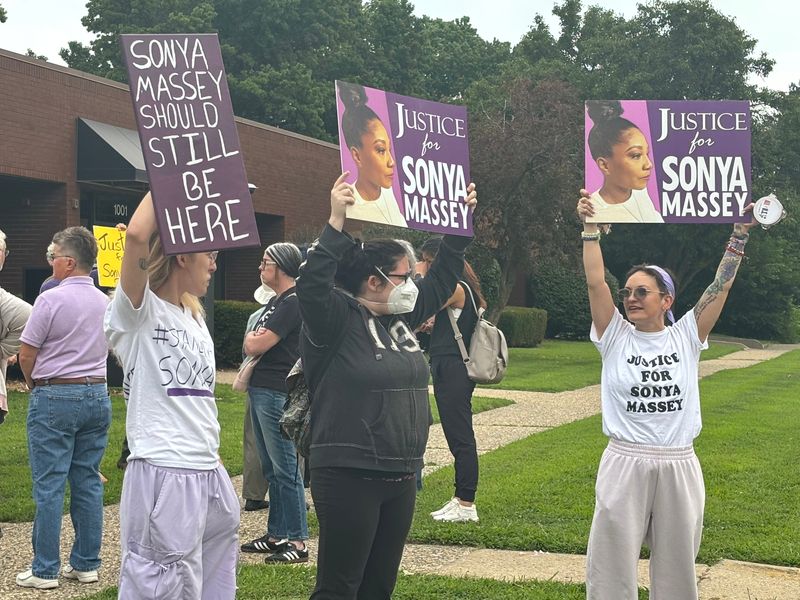 Supporters of Sonya Massey's family hold signs outside of the Illinois Prisoner Review Board meeting at 1001 N. Walnut St. in Springfield July 31 prior to a Medical Release Act hearing for Sean P. Grayson. Grayson, a former Sangamon County Sheriff's deputy, was convicted of her murder.