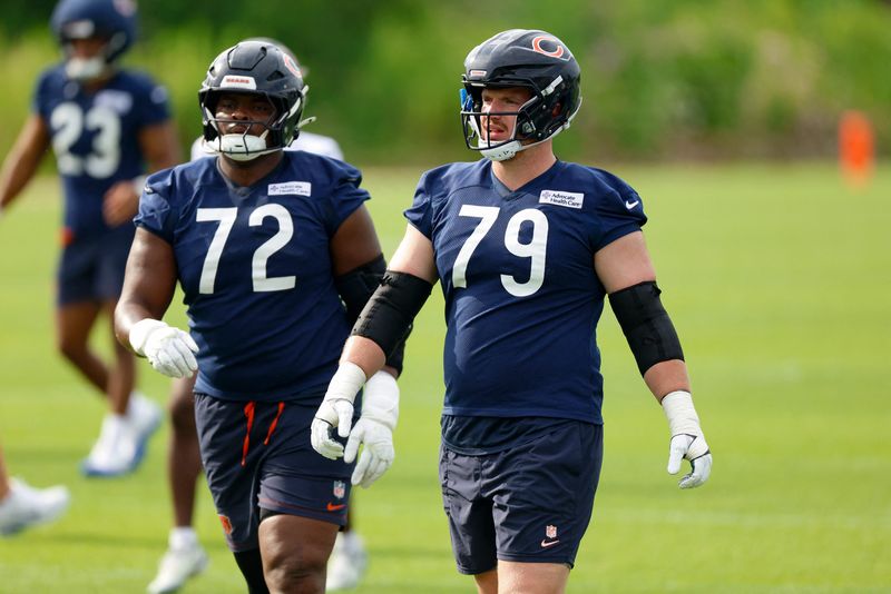 Jul 31, 2026; Lake Forest, IL, USA; Chicago Bears offensive tackle Kiran Amegadjie (72) and offensive tackle Theo Benedet (79) walk on the field during Training Camp at Halas Hall. Mandatory Credit: Kamil Krzaczynski-Imagn Images