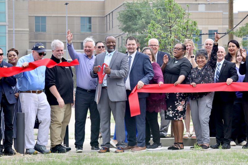 Howard Spearman, president of Rock Valley College, center, cuts the red ribbon during a grand opening celebration for the RVC Downtown West Campus on Aug. 14, 2026, in Rockford.