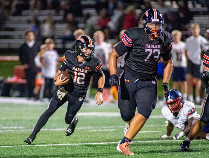 Harlem's Tyson Hill, No. 73, blocks for quarterback Braxton Fausett during their win over Belvidere North in Week 1 on Friday, Aug. 21, 2026, at Harlem High School.