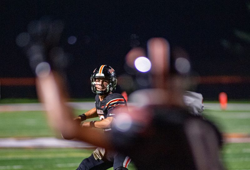 Harlem quarterback Braxton Fausett sets up to pass to Lebron McClelland, right, during their win over Belvidere North on Friday, Aug. 21, 2026, at Harlem High School.