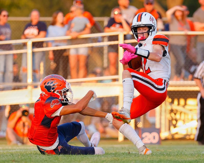 Hillsboro junior Noah Satterlee avoids a Pana defender on a 70-yard touchdown run in Hillsboro's 27-14 win at Pana on Friday, Aug. 21, 2026.