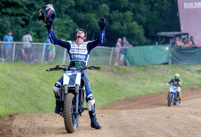 Dallas Daniels raises his arms in triumph after winning the Mission AFT SuperTwins Main Event at the Caterpillar Peoria TT races Saturday, Aug. 22, 2026 at the Peoria Motorcycle Club.