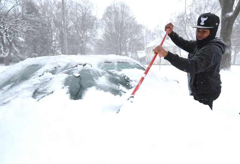 Kevin Byrd of Springfield cleans snow off his car on South Douglas Avenue on Wednesday, Feb. 2, 2022. [Thomas J. Turney/State Journal-Register]