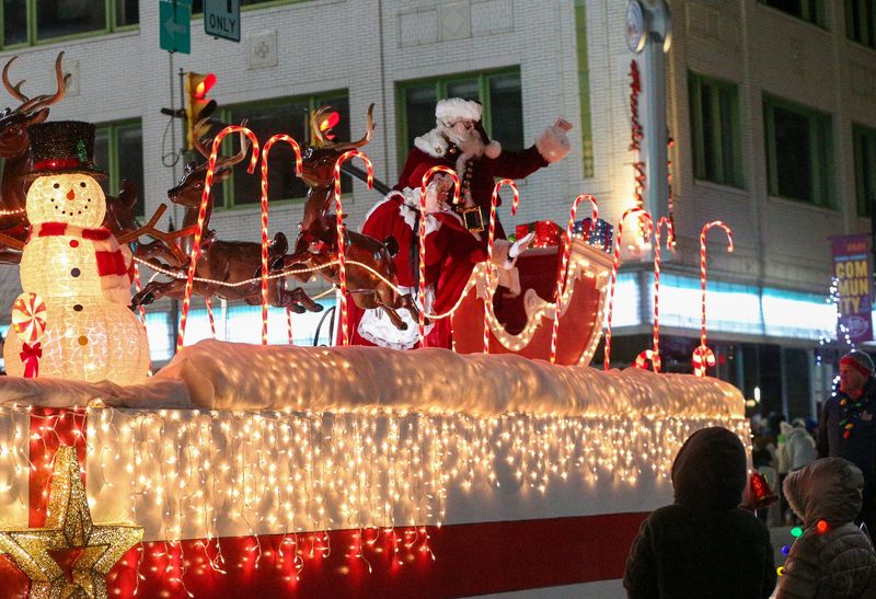 Mrs. Claus and Santa Claus wave at children who gathered for Greater Lafayette's annual Christmas Parade, "A Very Merry Main Street," Saturday, Dec. 3, 2022, in Lafayette, Ind.