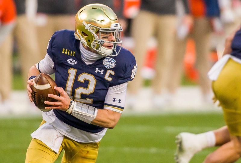 Notre Dame’s Ian Book (12) finished his college career as the winningest quarterback in Irish football history.