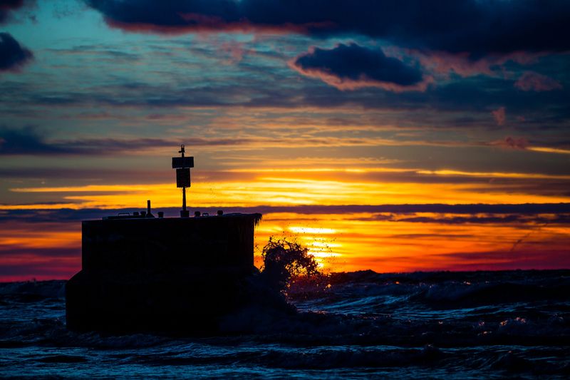 The sun sets over Lake Michigan at Weko Beach in Bridgman on Feb. 15, 2017. Weko Beach Summer Concerts are held on Sunday evenings from 7 to 9 p.m.