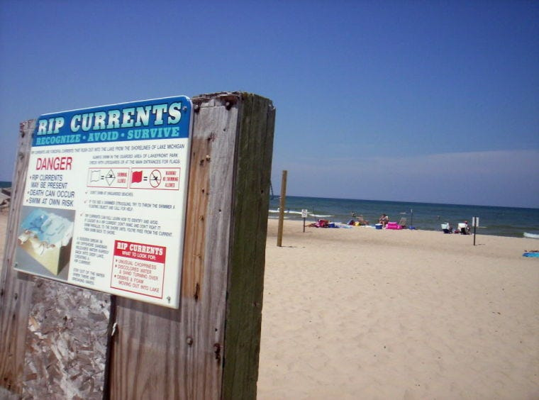 When Lake Michigan rip current/wave warnings are issued, beaches, such as the New Buffalo Beach (pictured here Aug. 2, 2006), generally post signs and red flags.