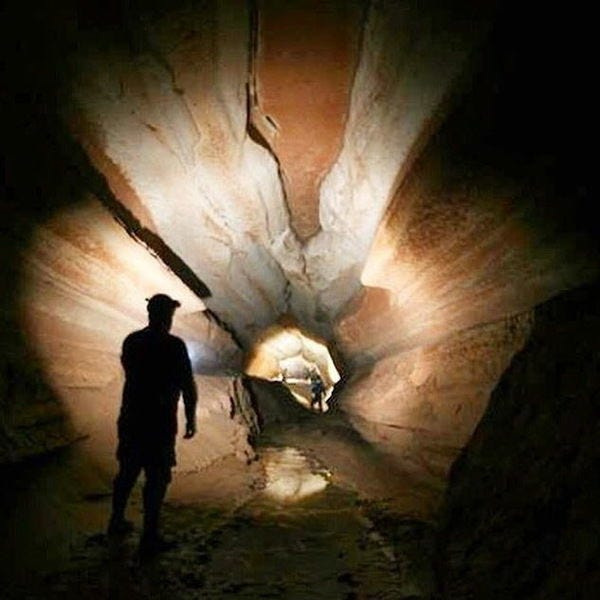 Cavers explore a passage in Bluespring Caverns, near Bedford. The cave is one of the Indiana settings used in Rick Riordan’s novel “The Dark Prophecy.”