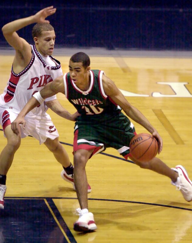 Lawrence North's Chris Hill (#10) drives on Pike's Chris Thomas (#30) in the first half of their game Tuesday night at Hinkle Fieldhouse.