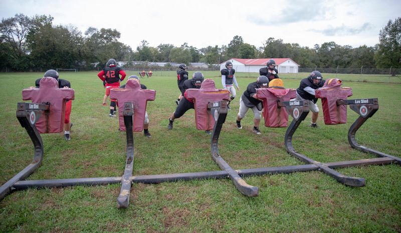 Kids work on a tackling sled on a recent afternoon that saw 21 kids suit up for practice at Edinburgh High School football practice, October 15, 2018. The team, winless on the year, has struggled as many small schools do, to find enough kids to field a team in the smallest Indiana division.