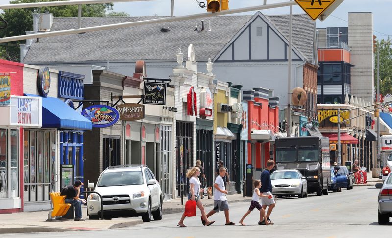 A family dashes across Broad Ripple Avenue in July.