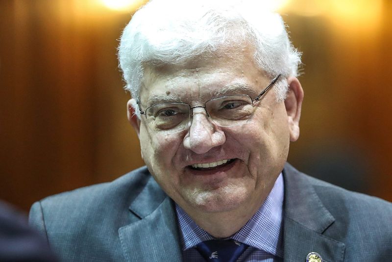 Rep. Ed Soliday talks with a colleague on the starting day of legislative session at the Indiana Statehouse, Indianapolis, Thursday, Jan. 3, 2019.