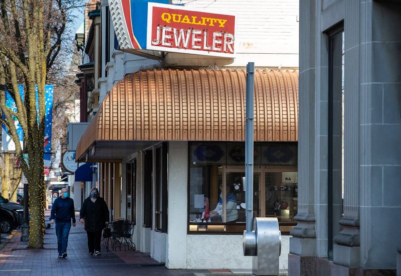 Shoppers make their way along Washington Street in Columbus, Ind., on Monday, Jan. 4, 2020.