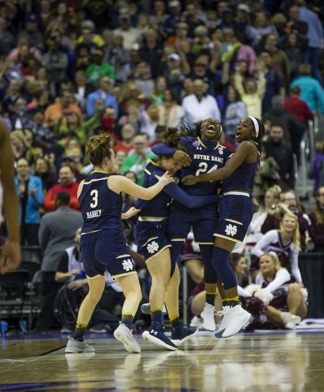 Notre Dame’s Marina Mabrey (3), from left, Kathryn Westbeld (33) Arike Ogunbowale (24) and Jackie Young (5) celebrate after Arike Ogunbowale (24) scored the winning 3-pointer in the final second of ND's title win over Mississippi State in the NCAA Women’s Tournament National Championship game, Sunday inside Nationwide Arena in Columbus, Ohio. (Tribune Photo/MICHAEL CATERINA)
