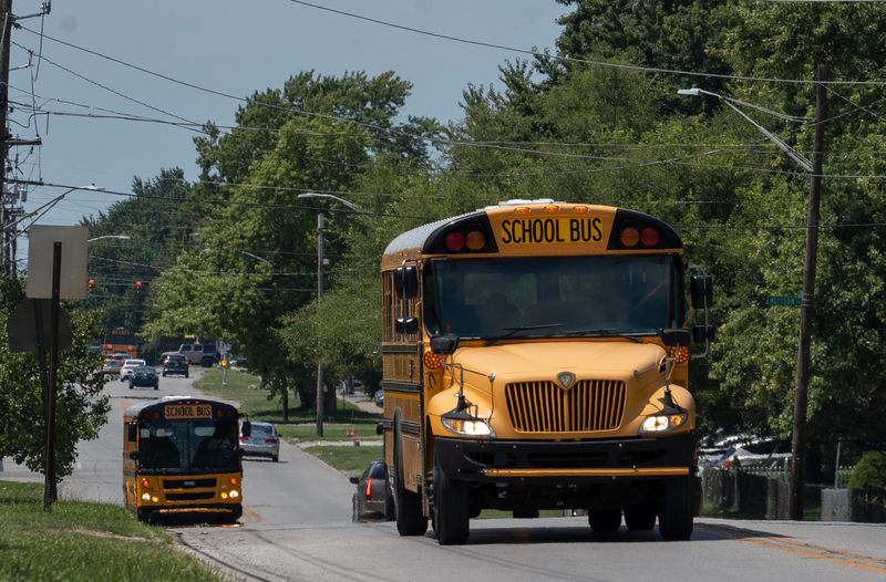 IPS school buses travel on west 34th St., Monday, July 31, 2023 on the first day of school for IPS schools.