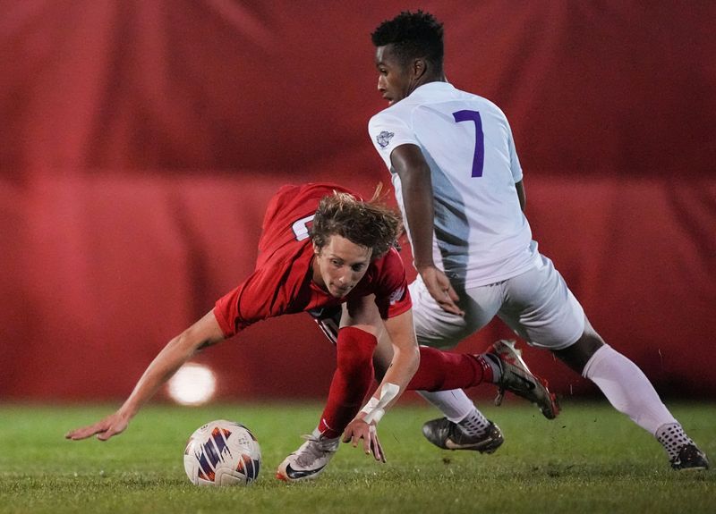 Fishers Tigers midfielder Denny Johnson (10) falls against Brownsburg Bulldogs Micah Eldridge (7) on Tuesday, Sept. 12, 2023, during the game at Fishers High School in Fishers. The Fishers Tigers defeated the Brownsburg Bulldogs, 4-1.